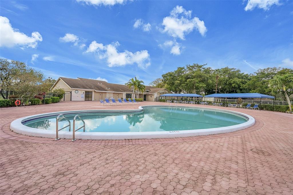 6195 Winding Brook Way Delray Beach, FL 33484 - Photo 56 of 68 a view of a swimming pool with a yard and plants