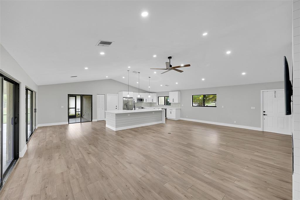 6195 Winding Brook Way Delray Beach, FL 33484 - Photo 6 of 68 a view of an empty room with window and wooden floor