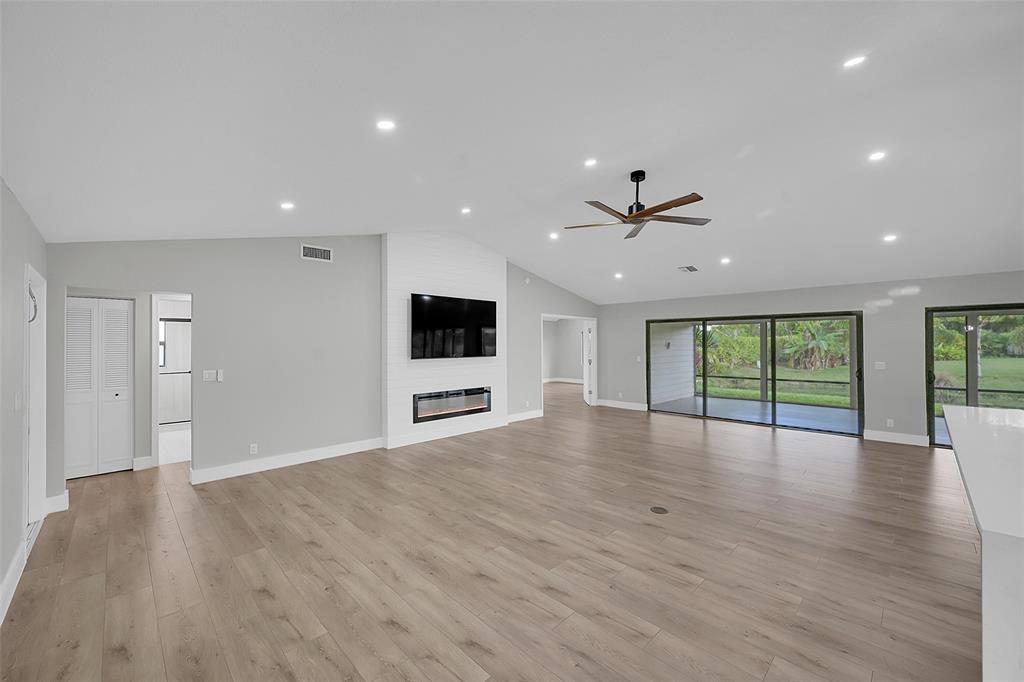 6195 Winding Brook Way Delray Beach, FL 33484 - Photo 7 of 68 a view of an empty room with wooden floor and a window