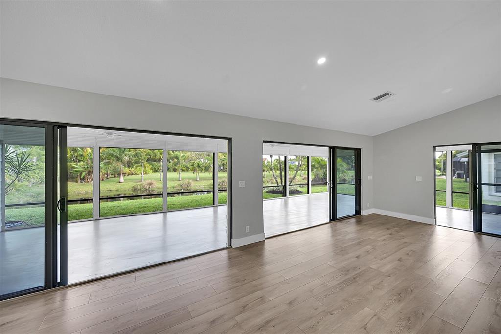 6195 Winding Brook Way Delray Beach, FL 33484 - Photo 10 of 68 a view of an empty room with wooden floor and a window