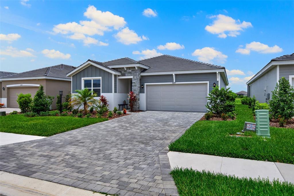 18237 Beach Ranch Terrace Bradenton, FL 34211 - Photo 3 of 72 a front view of a house with a garden