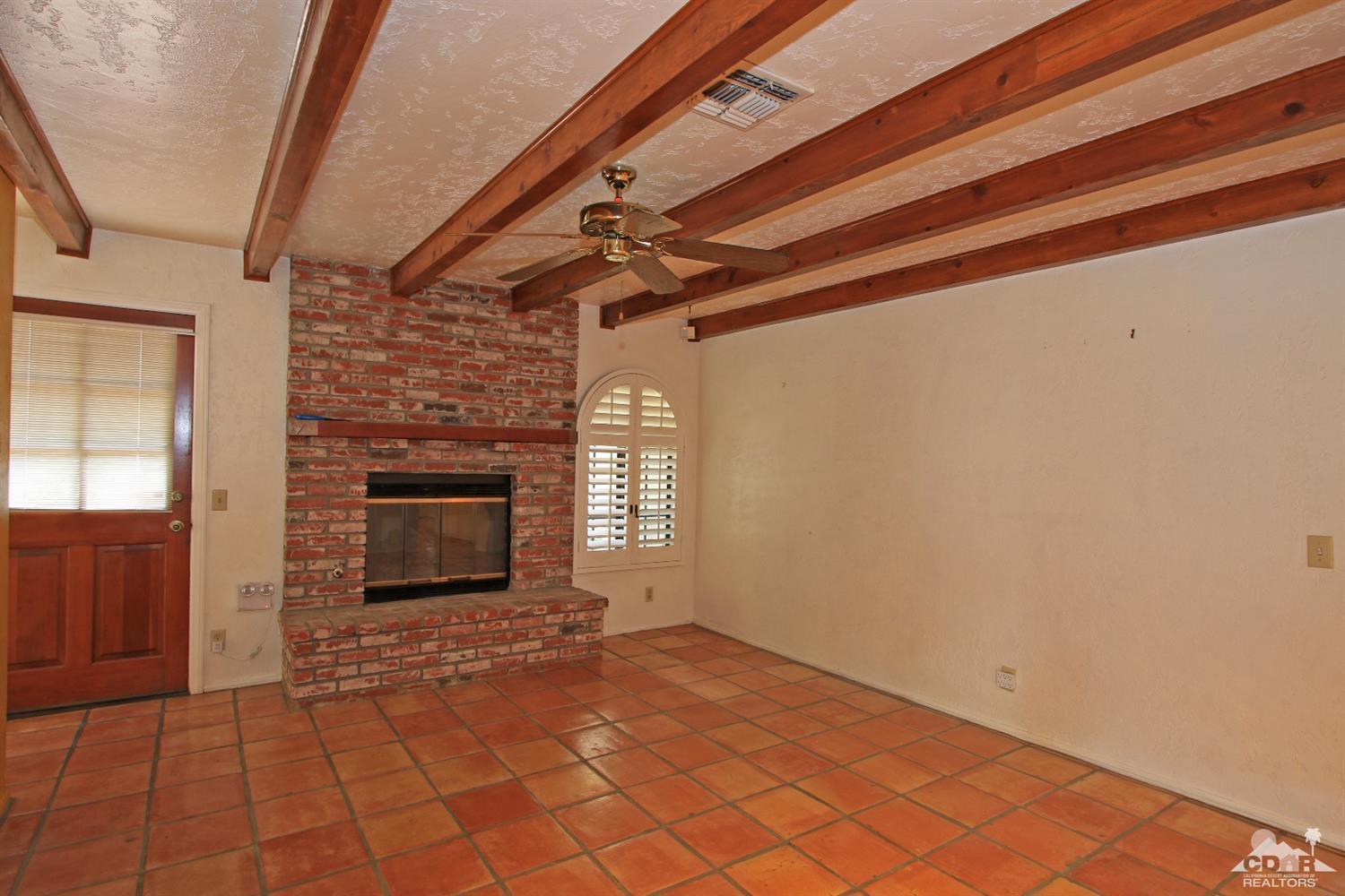 70400 Chappel Road Rancho Mirage, CA 92270 - Photo 16 of 49 a view of empty room with wooden floor and fireplace