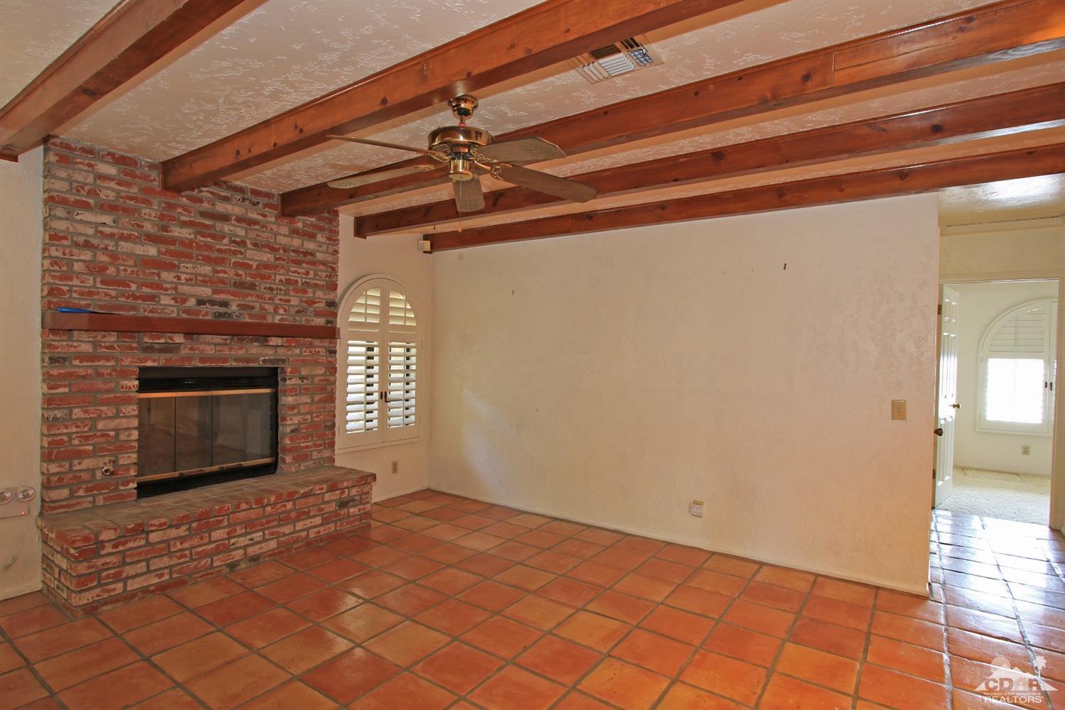 70400 Chappel Road Rancho Mirage, CA 92270 - Photo 19 of 49 a view of empty room with wooden floor and fireplace