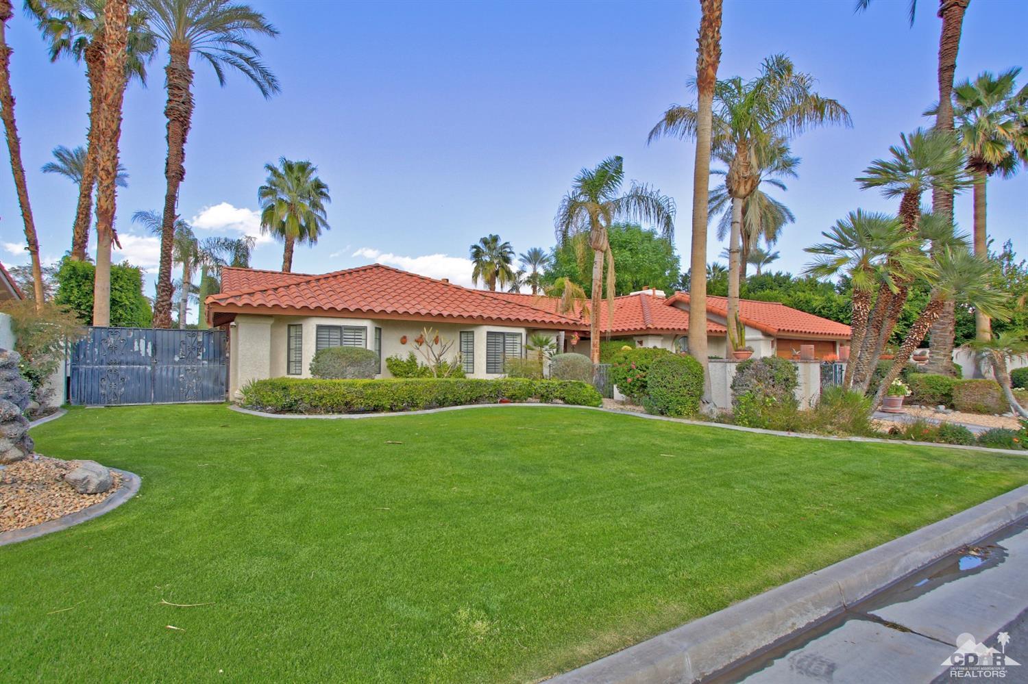 70400 Chappel Road Rancho Mirage, CA 92270 - Photo 3 of 49 a front view of a house with a yard and potted plants