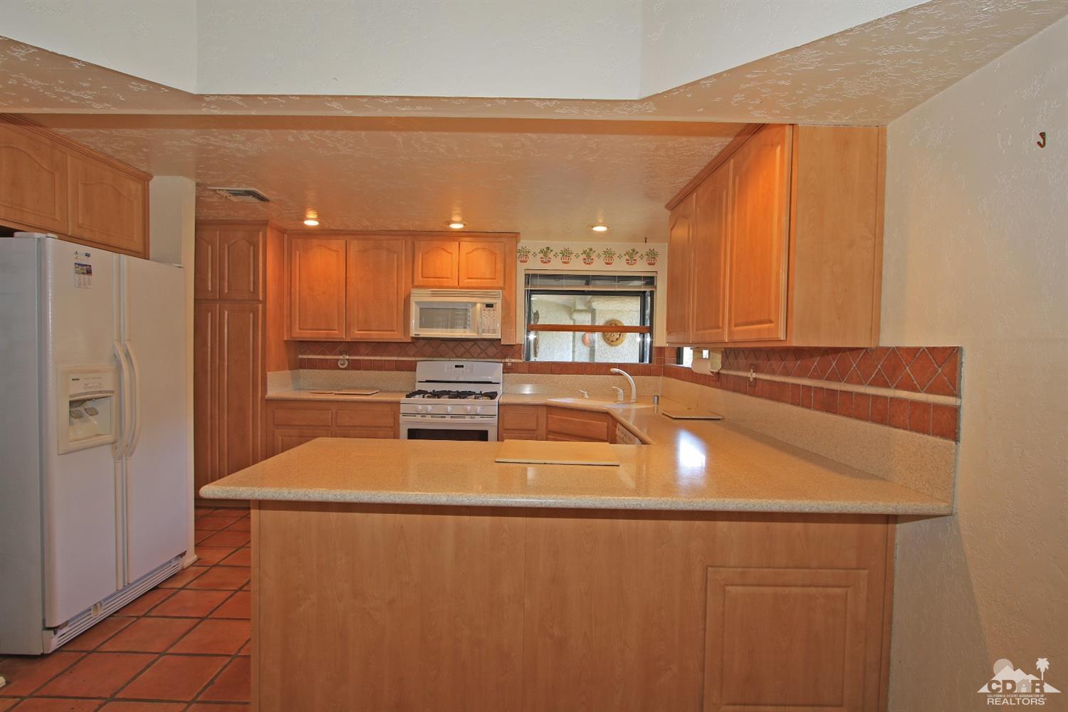 70400 Chappel Road Rancho Mirage, CA 92270 - Photo 24 of 49 a kitchen with stainless steel appliances a refrigerator and stove