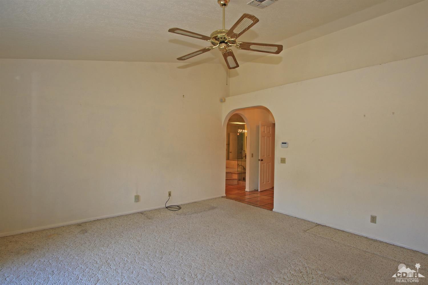 70400 Chappel Road Rancho Mirage, CA 92270 - Photo 29 of 49 an empty room with a ceiling fan and a window