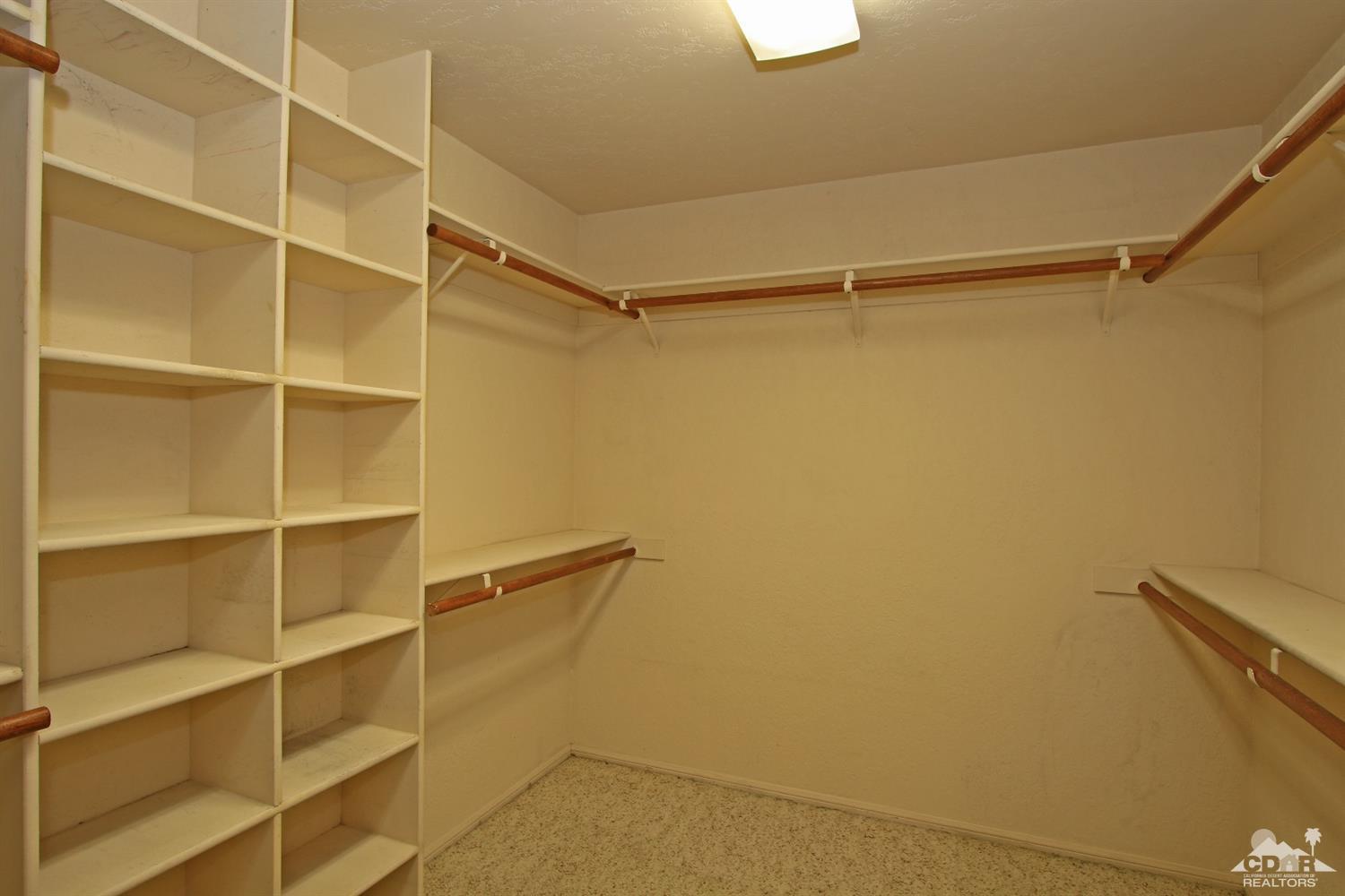 70400 Chappel Road Rancho Mirage, CA 92270 - Photo 31 of 49 a view of walk in closet with empty racks