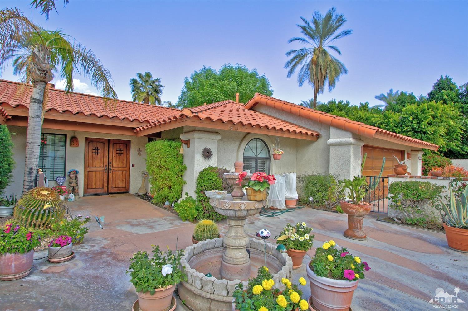 70400 Chappel Road Rancho Mirage, CA 92270 - Photo 5 of 49 a front view of a house with a porch and outdoor seating