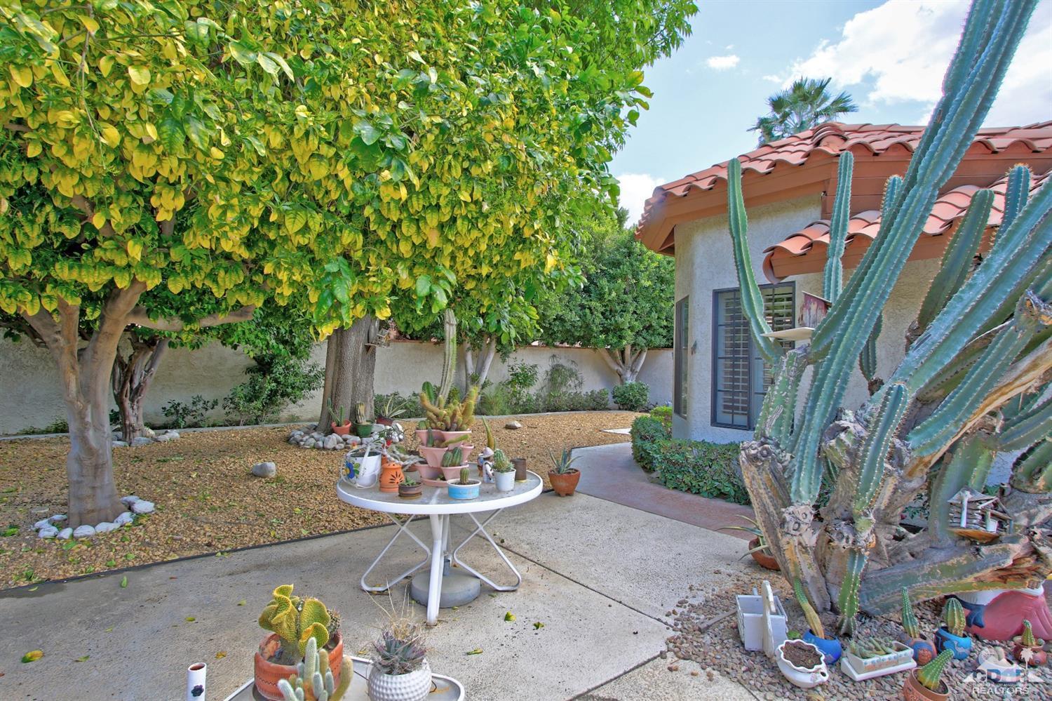70400 Chappel Road Rancho Mirage, CA 92270 - Photo 47 of 49 a view of a patio with table and chairs and potted plants
