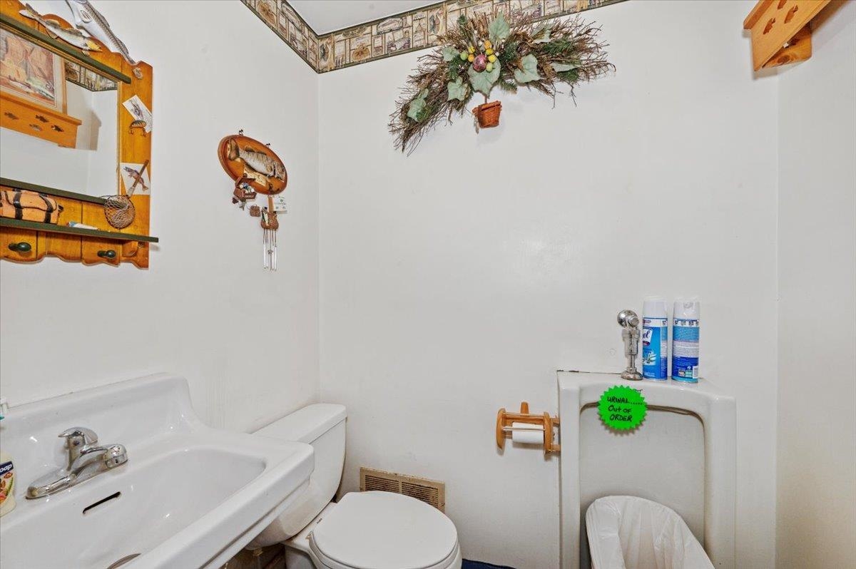 3729 East 2nd Street Superior, WI 54880 - Photo 20 of 20 Half bath featuring toilet, visible vents, and a sink