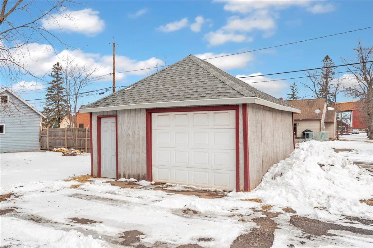 3729 East 2nd Street Superior, WI 54880 - Photo 5 of 20 Snow covered garage with a detached garage and fence