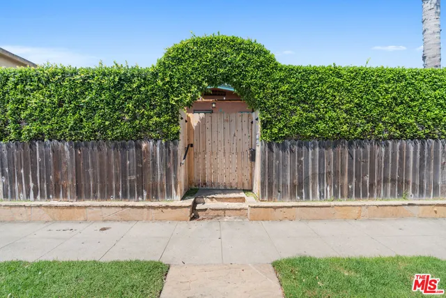 a small yard with wooden fence