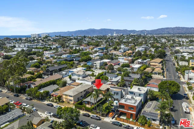 an aerial view of residential houses with city view
