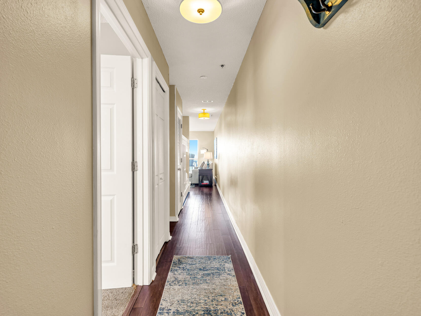 144 Spires Lane, Unit 410 Santa Rosa Beach, FL 32459 - Photo 1 of 33 a view of a hallway with wooden floor and staircase