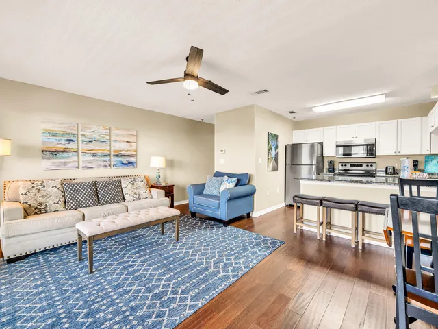 a living room with furniture and kitchen view