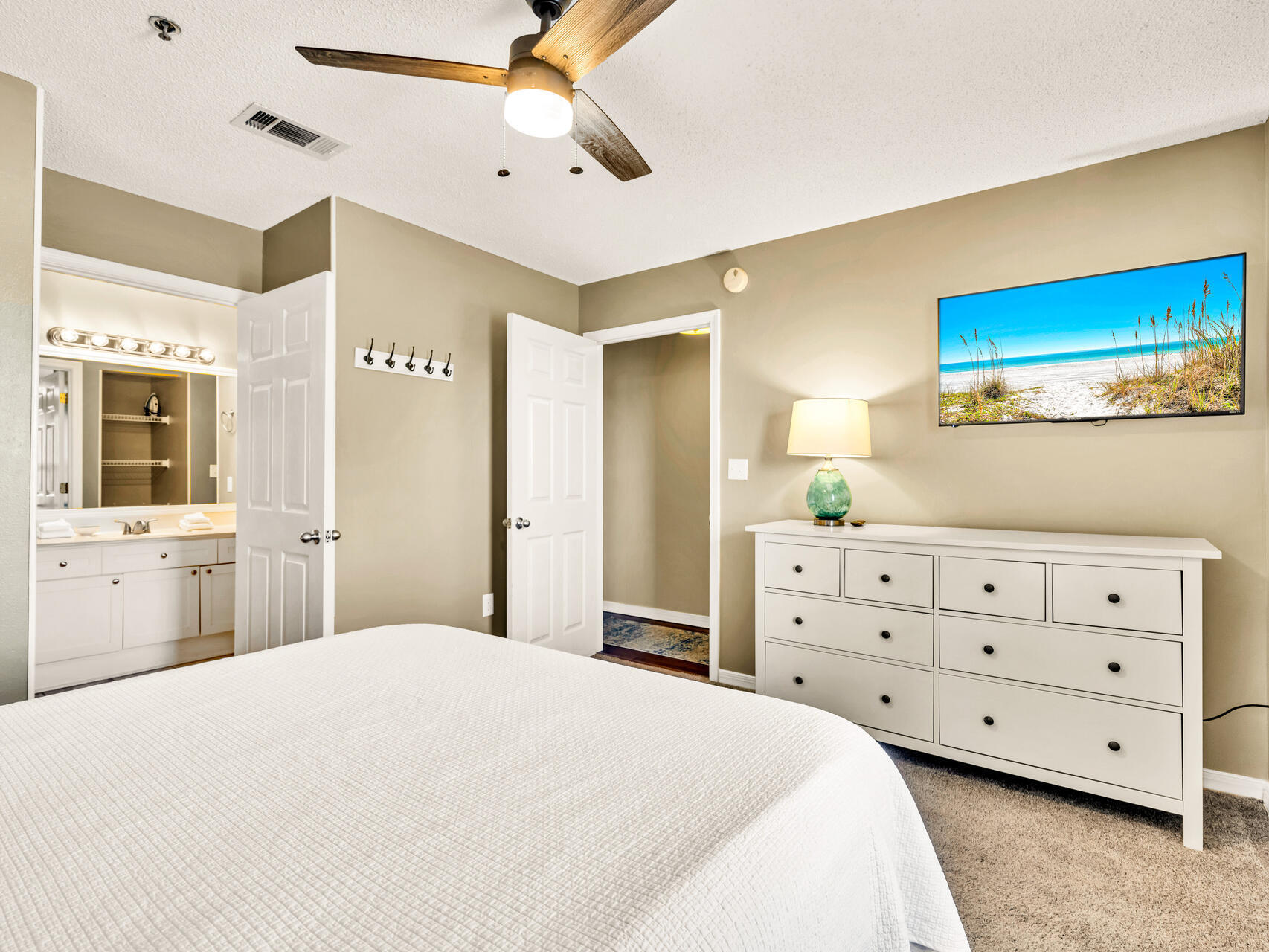 144 Spires Lane, Unit 410 Santa Rosa Beach, FL 32459 - Photo 3 of 33 a bedroom with a bed a dresser and a flat screen tv