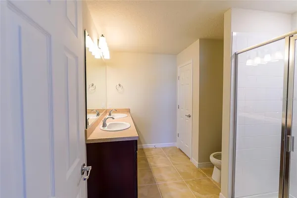 a bathroom with a sink a mirror and a shower