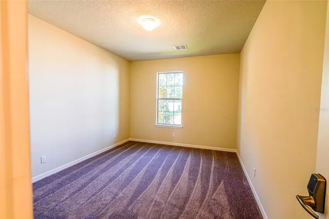 a view of a room with wooden floor and window