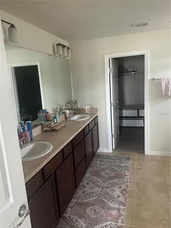 a bathroom with a double vanity sink and mirror