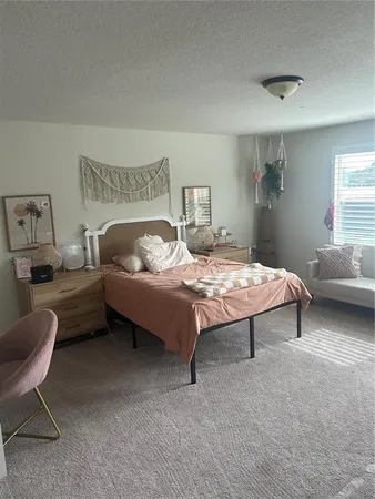 a bedroom with a bed chair and a couch