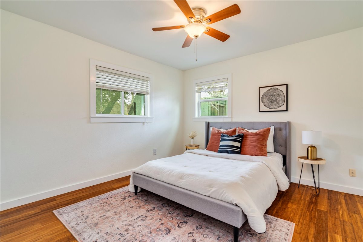 2505 Riddle Road Austin, TX 78748 - Photo 6 of 8 a bedroom with a bed and wooden floor