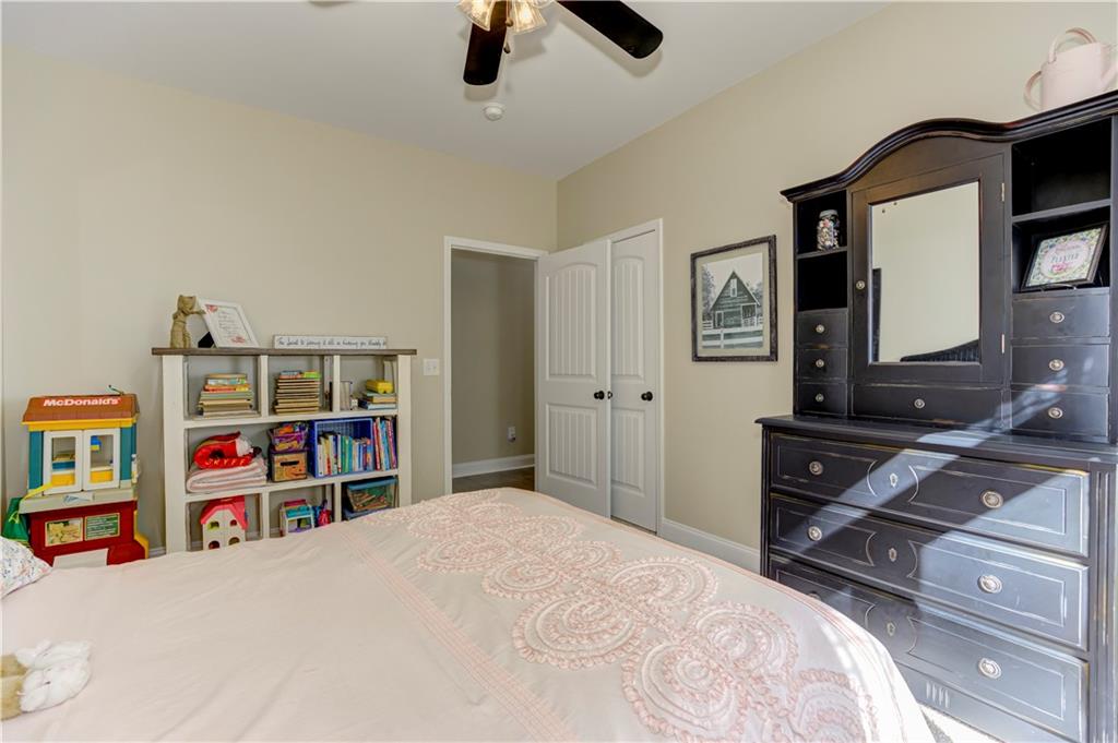 304 Garland Way Canton, GA 30115 - Photo 111 of 138 a bedroom with a bed and a book shelf