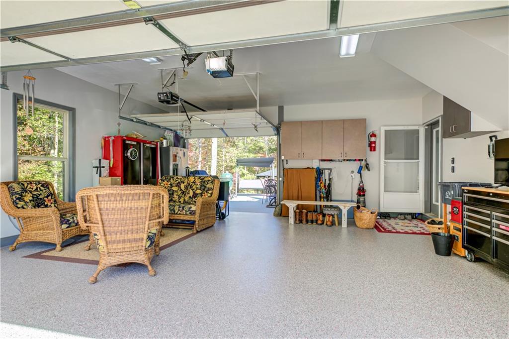 304 Garland Way Canton, GA 30115 - Photo 124 of 138 a living room with furniture and a flat screen tv