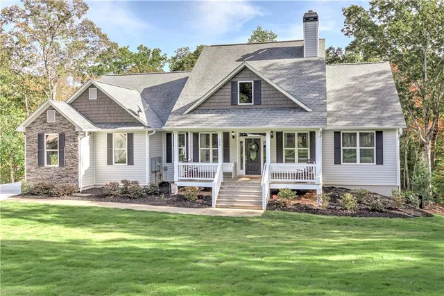 a kitchen with stainless steel appliances granite countertop a stove top oven a sink dishwasher a refrigerator and a refrigerator with wooden floor