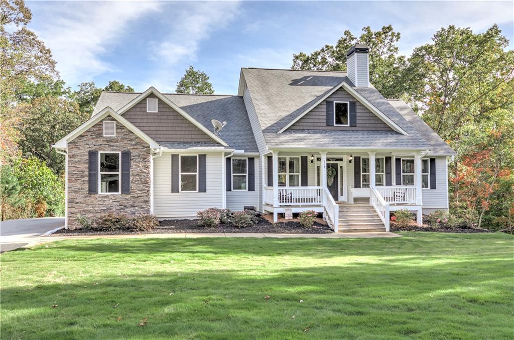 304 Garland Way Canton, GA 30115 - Photo 15 of 138 a front view of a house with a garden and trees