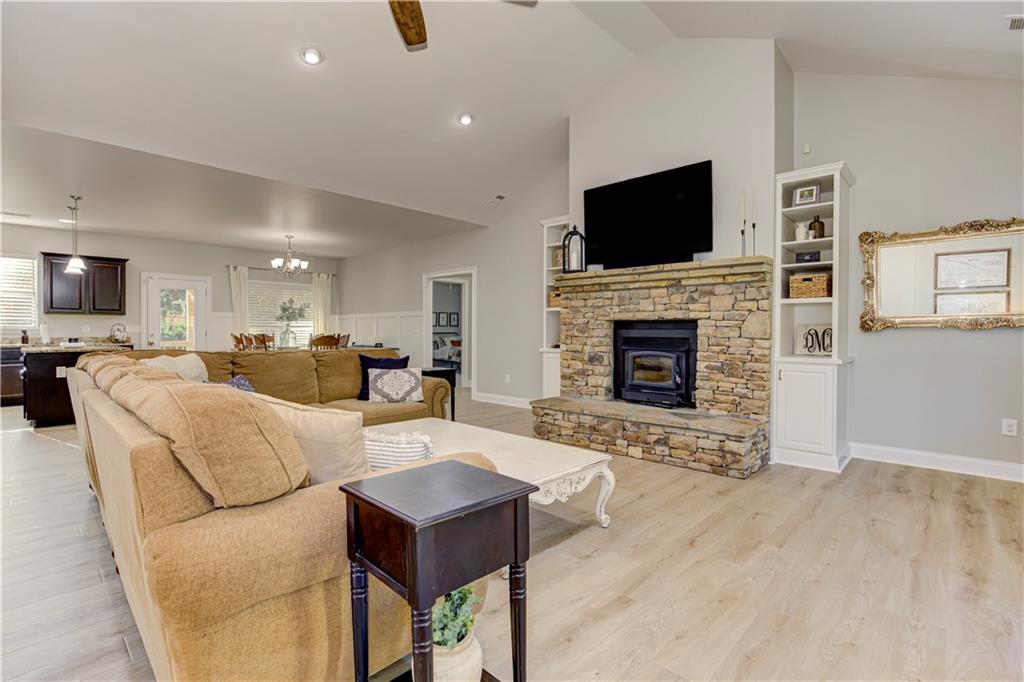 304 Garland Way Canton, GA 30115 - Photo 24 of 138 a living room with furniture a fireplace and a flat screen tv