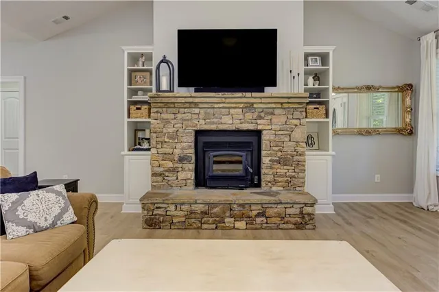 a living room with furniture and a ceiling fan
