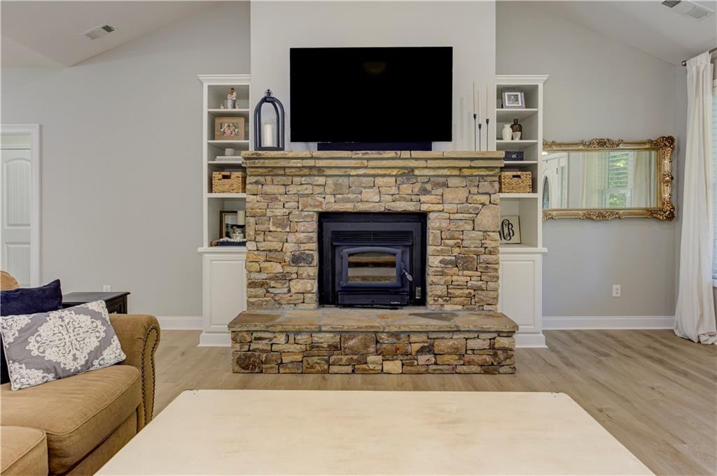 304 Garland Way Canton, GA 30115 - Photo 26 of 138 a living room with furniture a flat screen tv and a fireplace