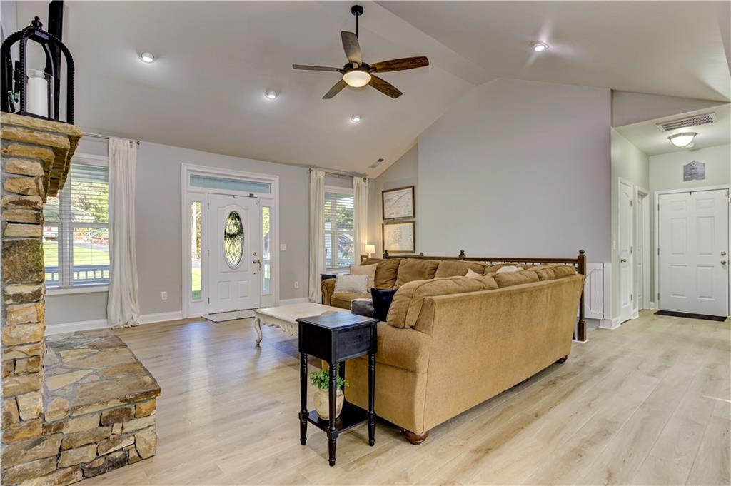 304 Garland Way Canton, GA 30115 - Photo 28 of 138 a living room with furniture and a chandelier