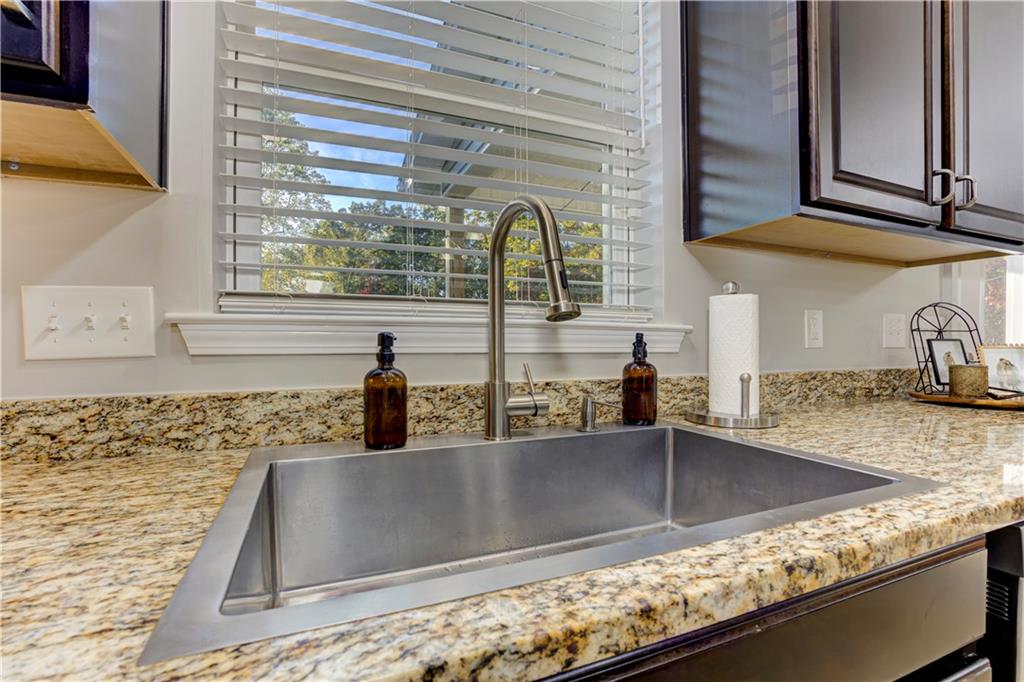 304 Garland Way Canton, GA 30115 - Photo 35 of 138 a kitchen with stainless steel appliances granite countertop a sink and a window