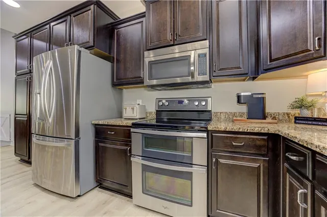 wooden floor in an empty room and a en suite bathroom with sink
