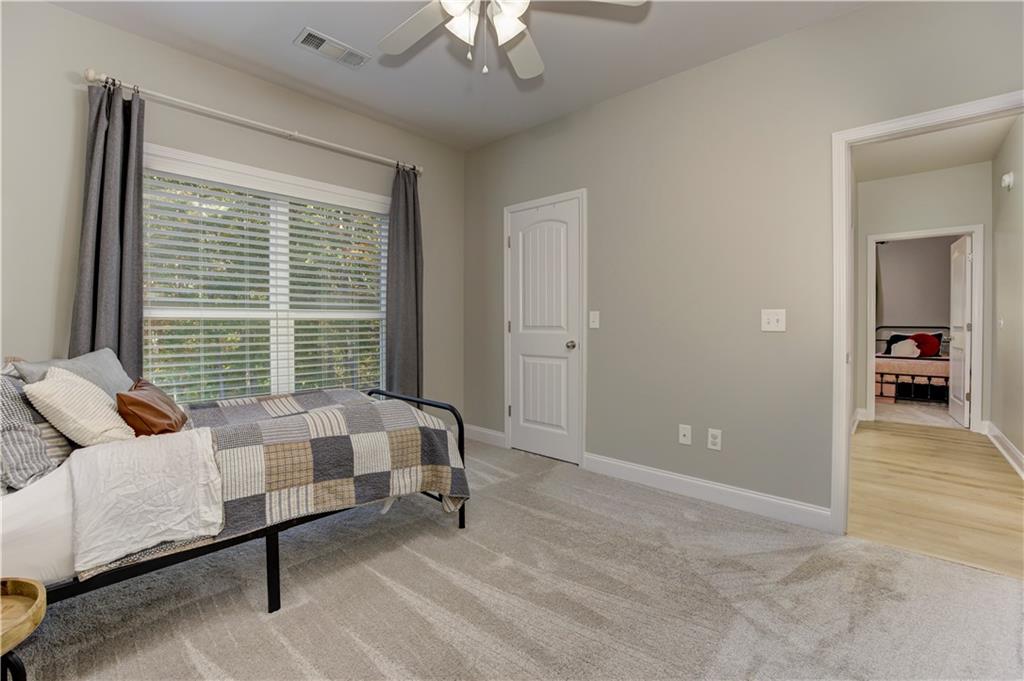 304 Garland Way Canton, GA 30115 - Photo 51 of 138 a spacious bedroom with a bed and a chandelier