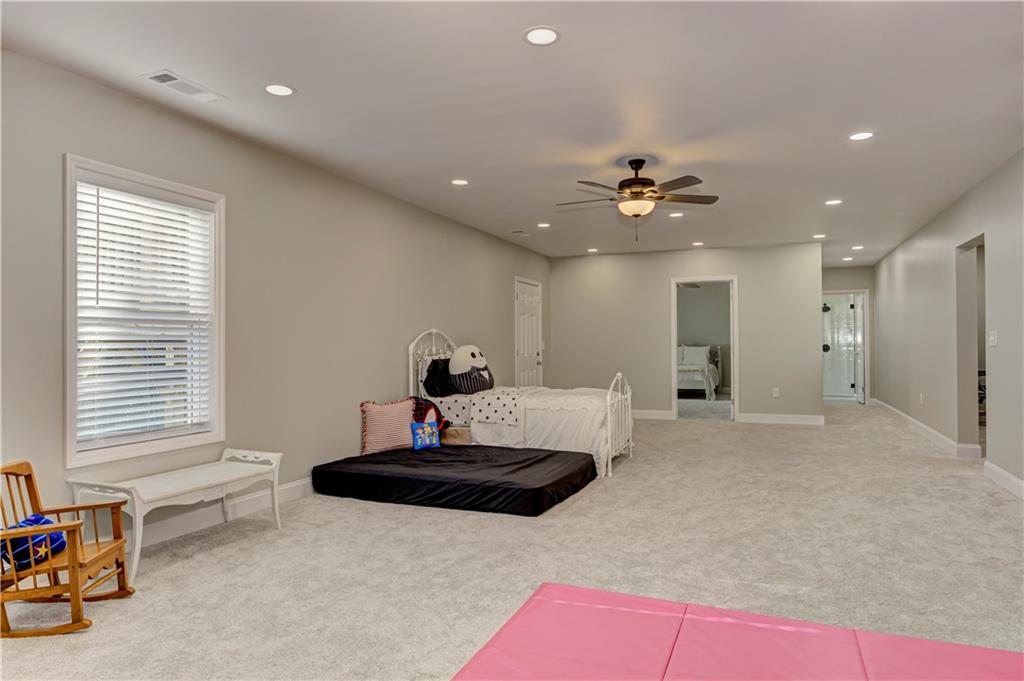 304 Garland Way Canton, GA 30115 - Photo 62 of 138 a living room with furniture and a ceiling fan