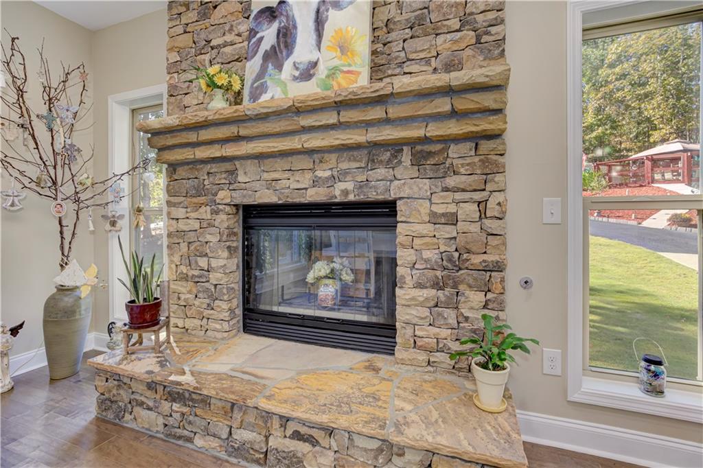 304 Garland Way Canton, GA 30115 - Photo 100 of 138 a living room with a fireplace with a potted plant