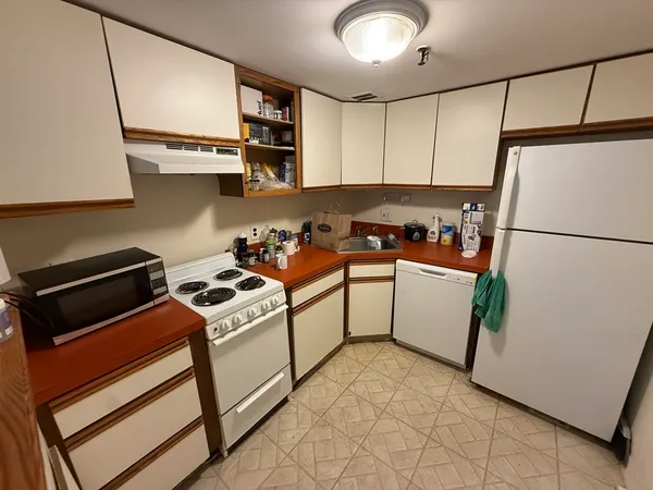 a utility room with dryer washer and a refrigerator