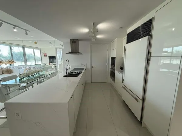 a kitchen with stainless steel appliances a refrigerator and a stove