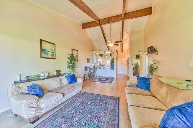 a dining room with furniture and a chandelier