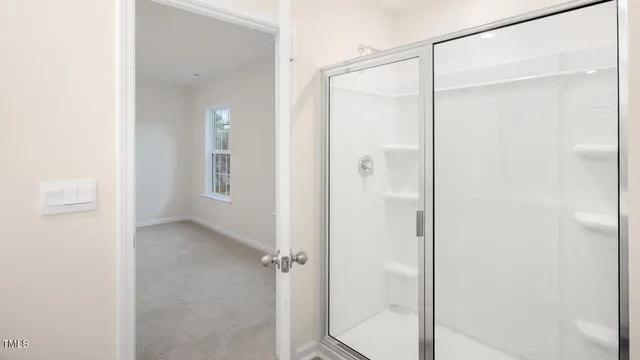 a bathroom with a glass shower door