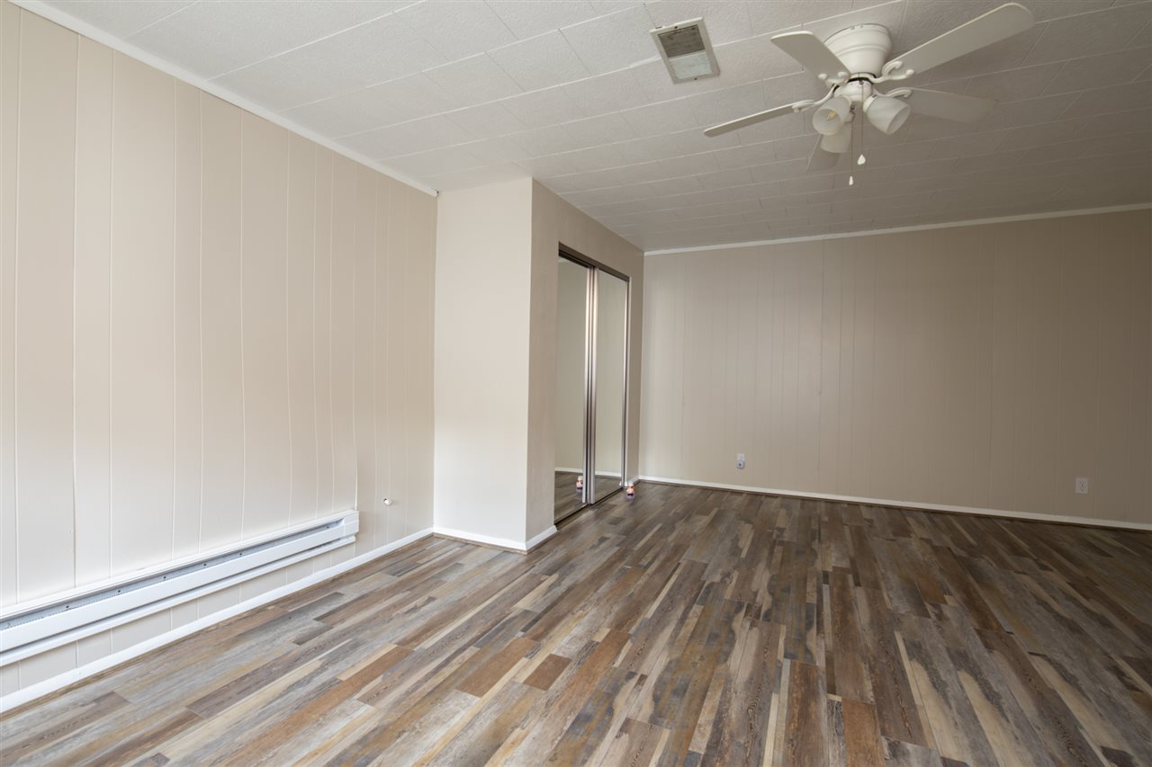 7712 Randy Road Machesney Park, IL 61115 - Photo 11 of 25 wooden floor in an empty room