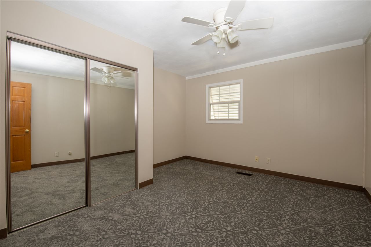 7712 Randy Road Machesney Park, IL 61115 - Photo 13 of 25 an empty room with windows and fan