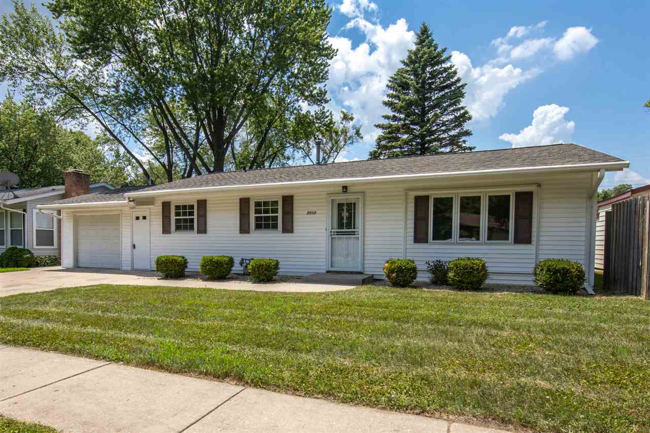 7712 Randy Road Machesney Park, IL 61115 - Photo 2 of 25 a front view of a house with a yard and porch