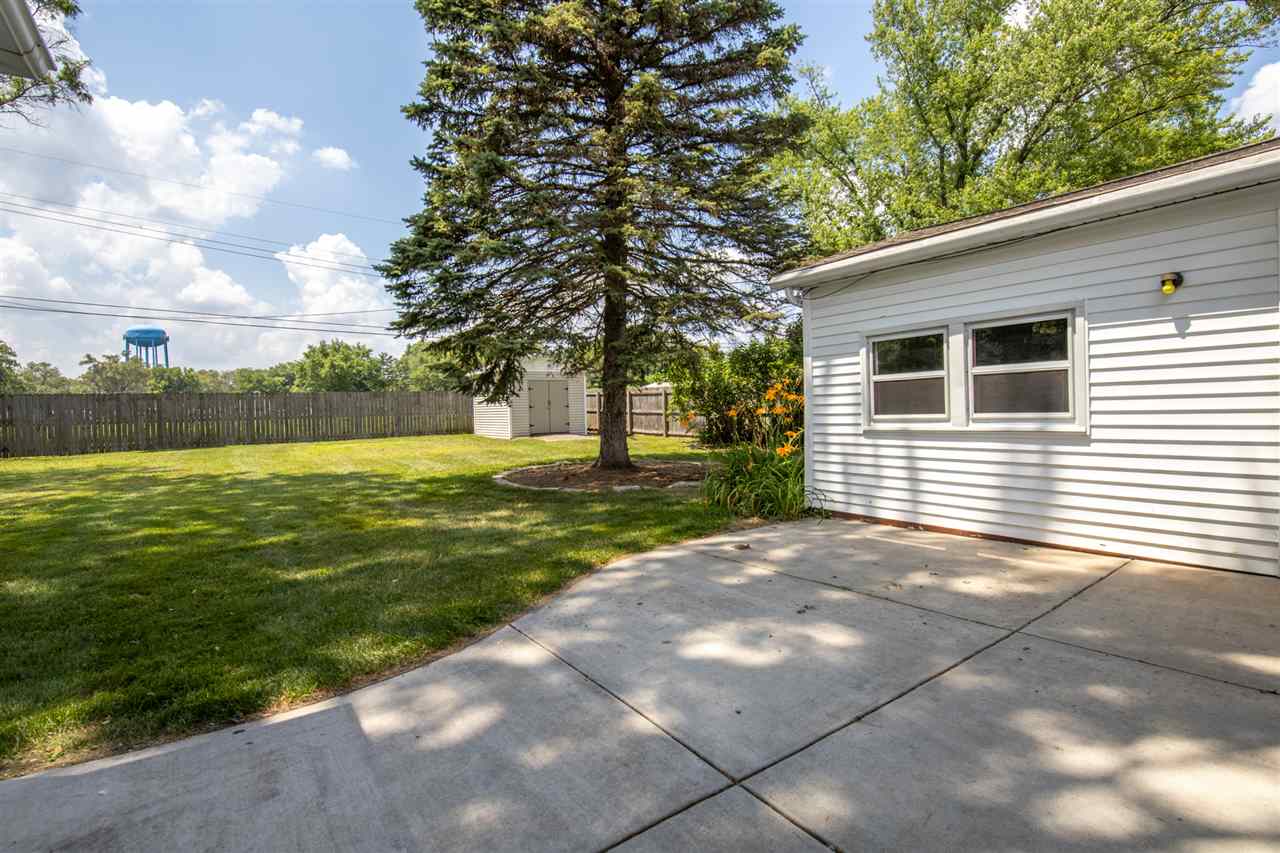 7712 Randy Road Machesney Park, IL 61115 - Photo 21 of 25 a view of a backyard with plants and large trees