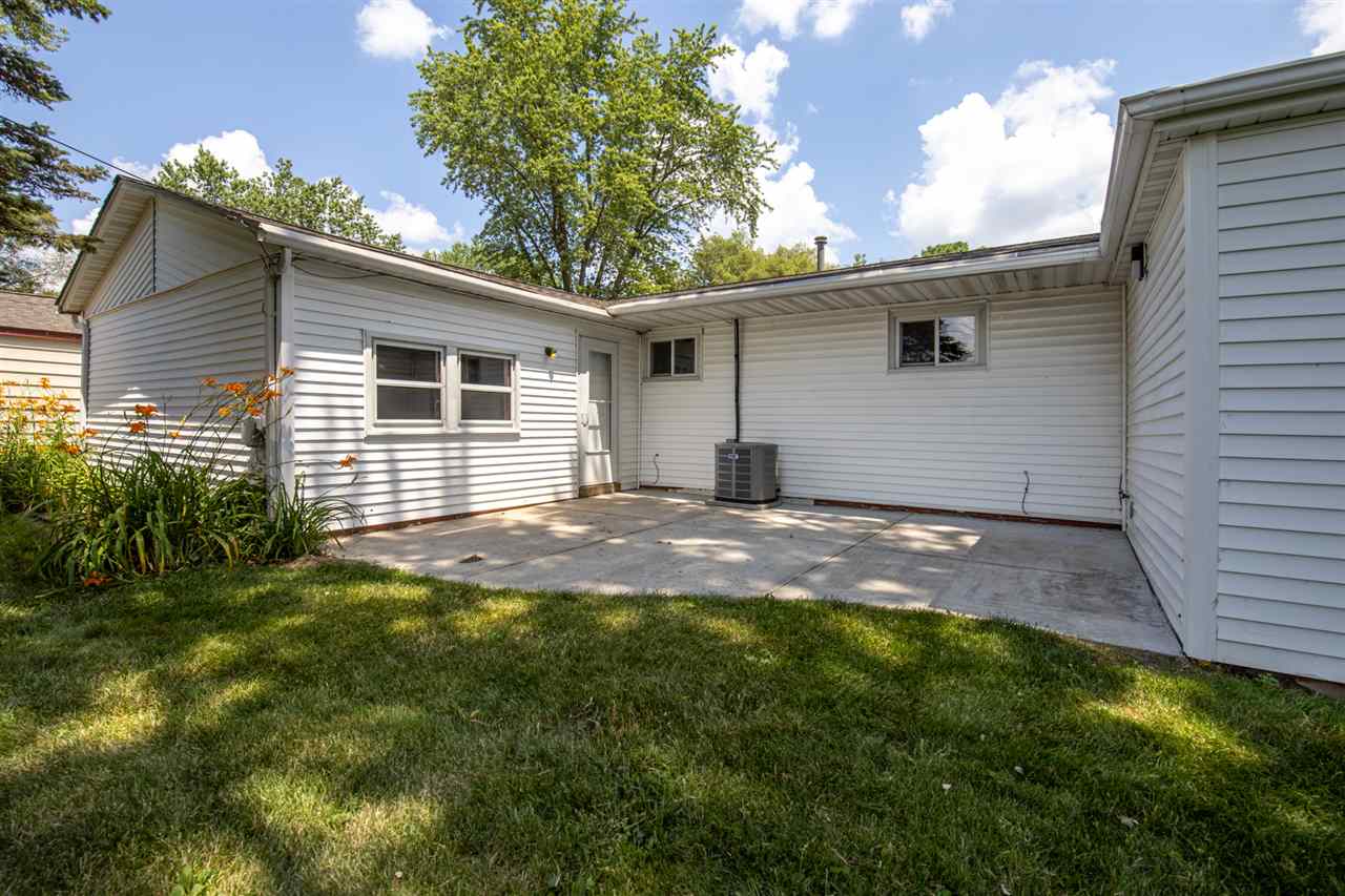 7712 Randy Road Machesney Park, IL 61115 - Photo 25 of 25 a backyard of a house with plants and barbeque oven