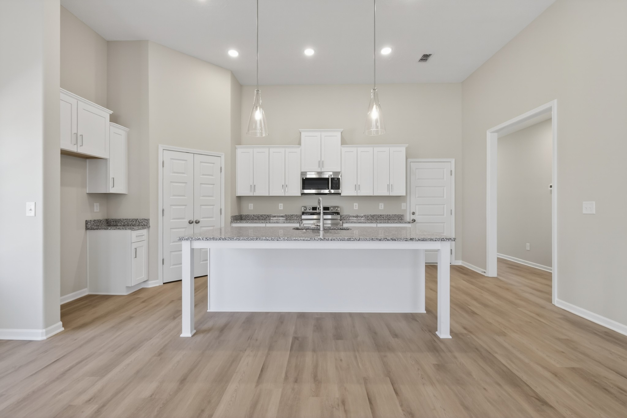 346 North Fork Branch Road Tullahoma, TN 37388 - Photo 13 of 37 a view of kitchen with granite countertop stainless steel appliances refrigerator oven stove and white cabinets with wooden floor