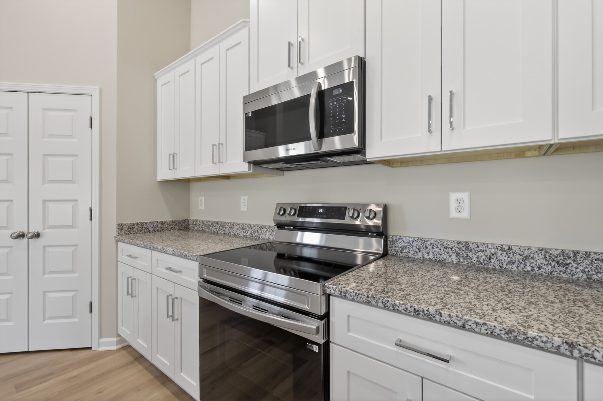 346 North Fork Branch Road Tullahoma, TN 37388 - Photo 15 of 37 a kitchen with stainless steel appliances granite countertop white cabinets and a stove a oven with wooden floor