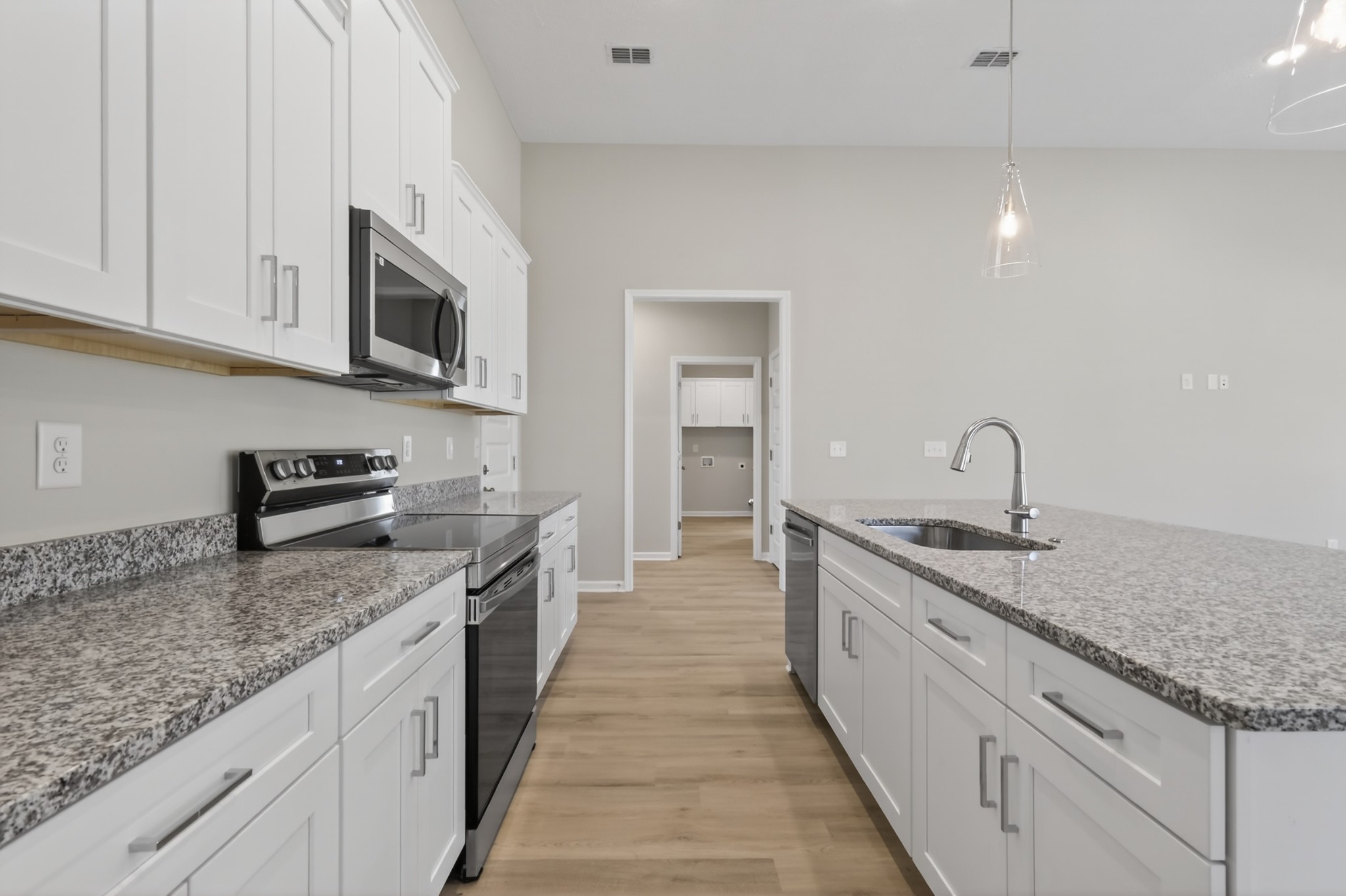 346 North Fork Branch Road Tullahoma, TN 37388 - Photo 17 of 37 a large kitchen with granite countertop a sink and dishwasher a stove top oven with wooden floor